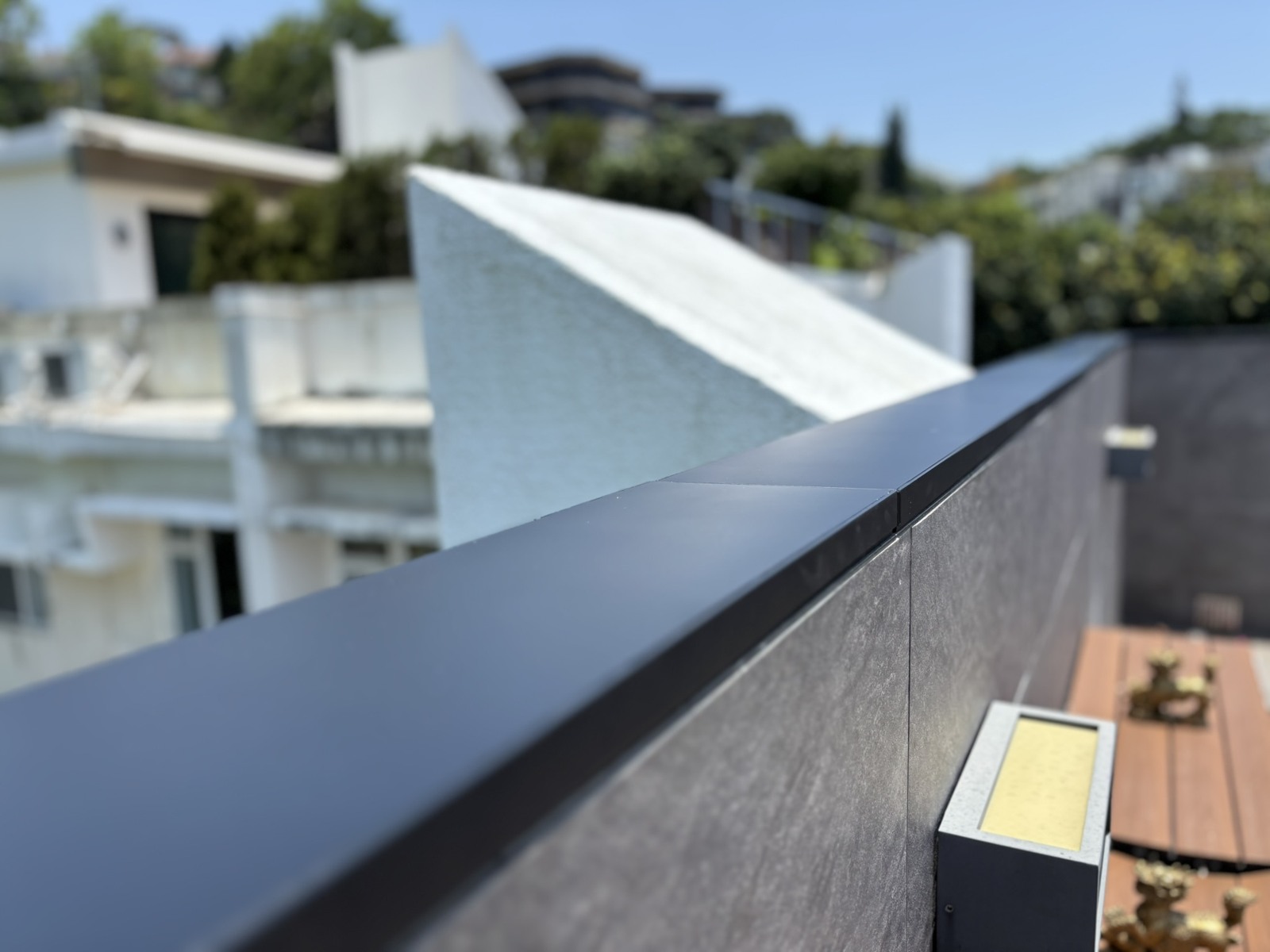 Real Apeiron Guard wall-top installation showing an outdoor service-access point